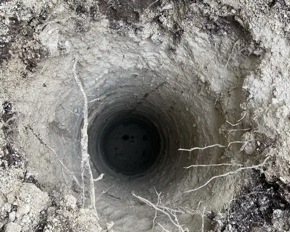 An excavation job involving an auger hole in the ground.